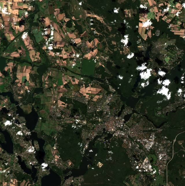 Sentinel-2 view of Potsdam: green forests, fields, urban areas and the dark Havel lakes, with scattered clouds